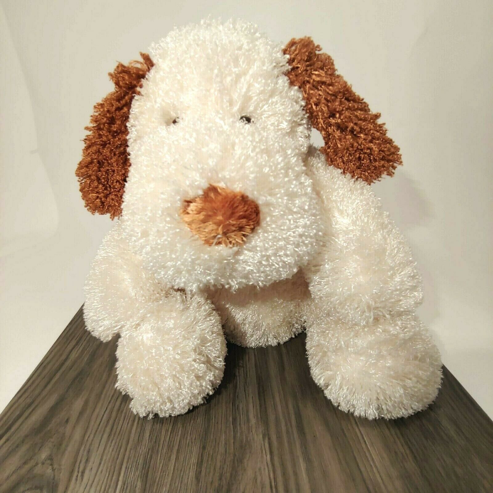 white stuffed dog with brown ears