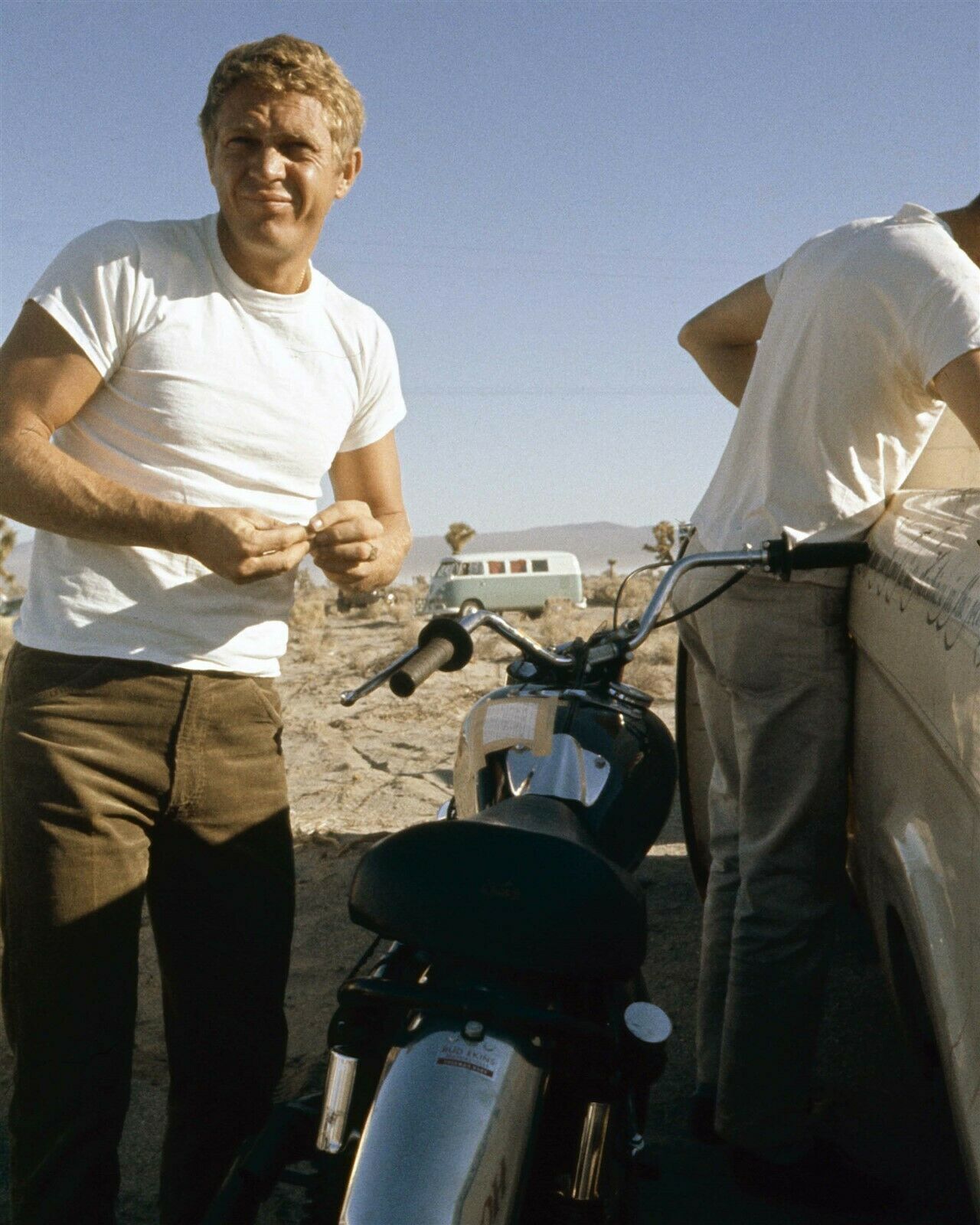 Steve McQueen in white t-shirt stands next to bike in desert 1960's 5x7 photo