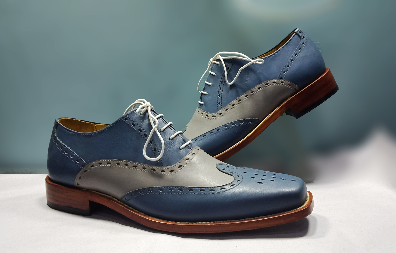 brown and blue wingtip shoes