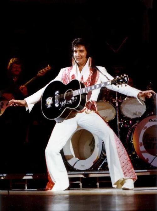 Elvis Presley on stage wearing his Red and 50 similar items