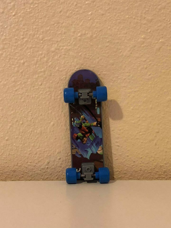 ninja turtle toy on skateboard