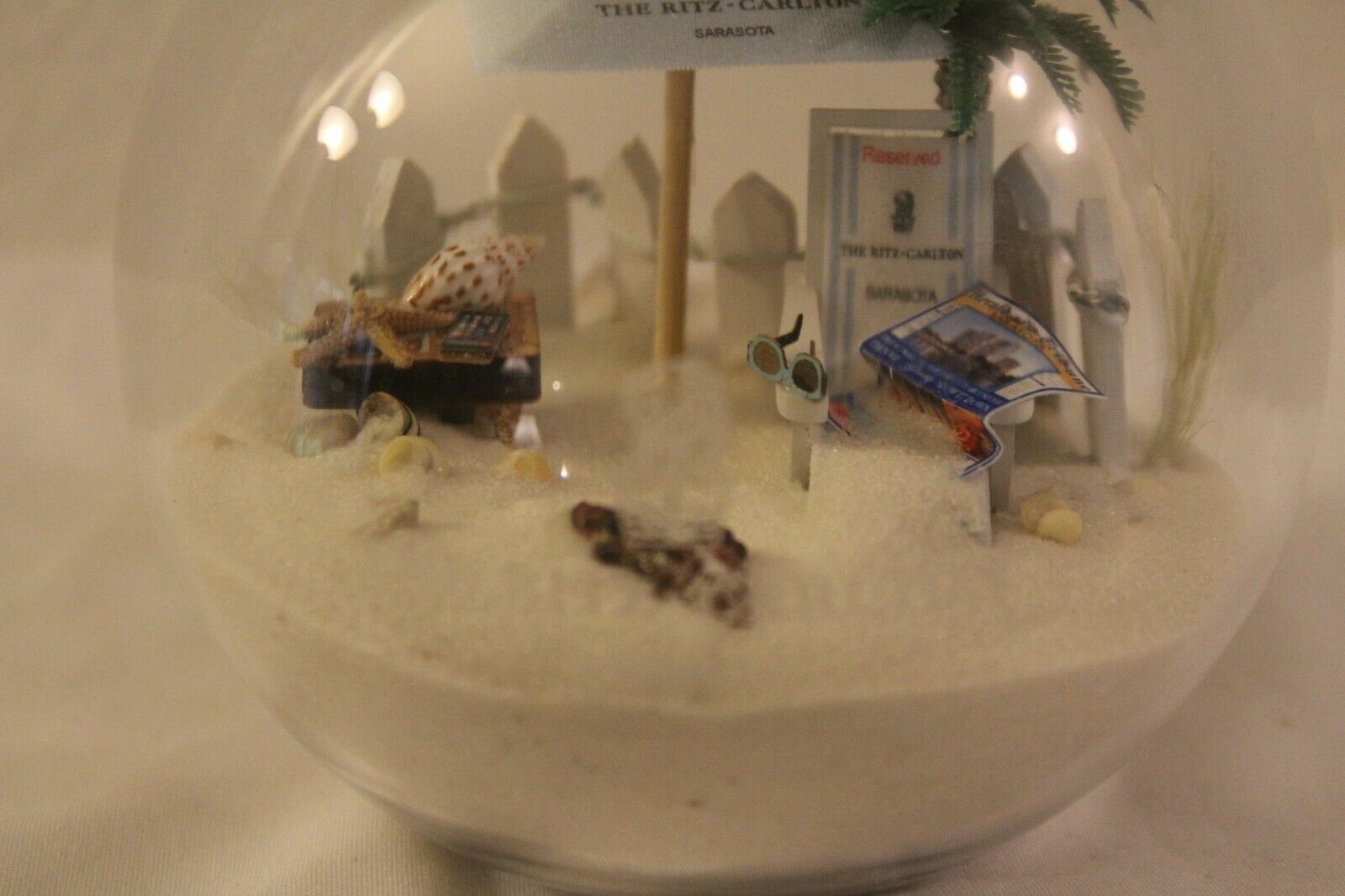 Primary image for Art Glass  Sand Sea Shells Beach chair Umbrella  Globe  4” Tall Ritz Carlton
