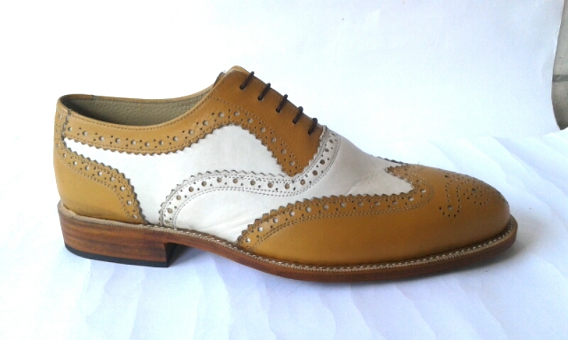 tan and white wingtip shoes