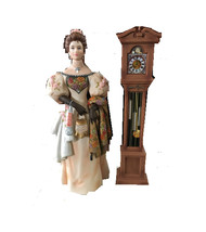 Lady standing next to grand father clock thumb200