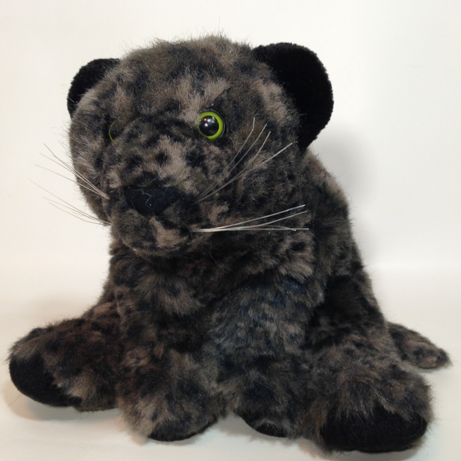 plush black cat with green eyes