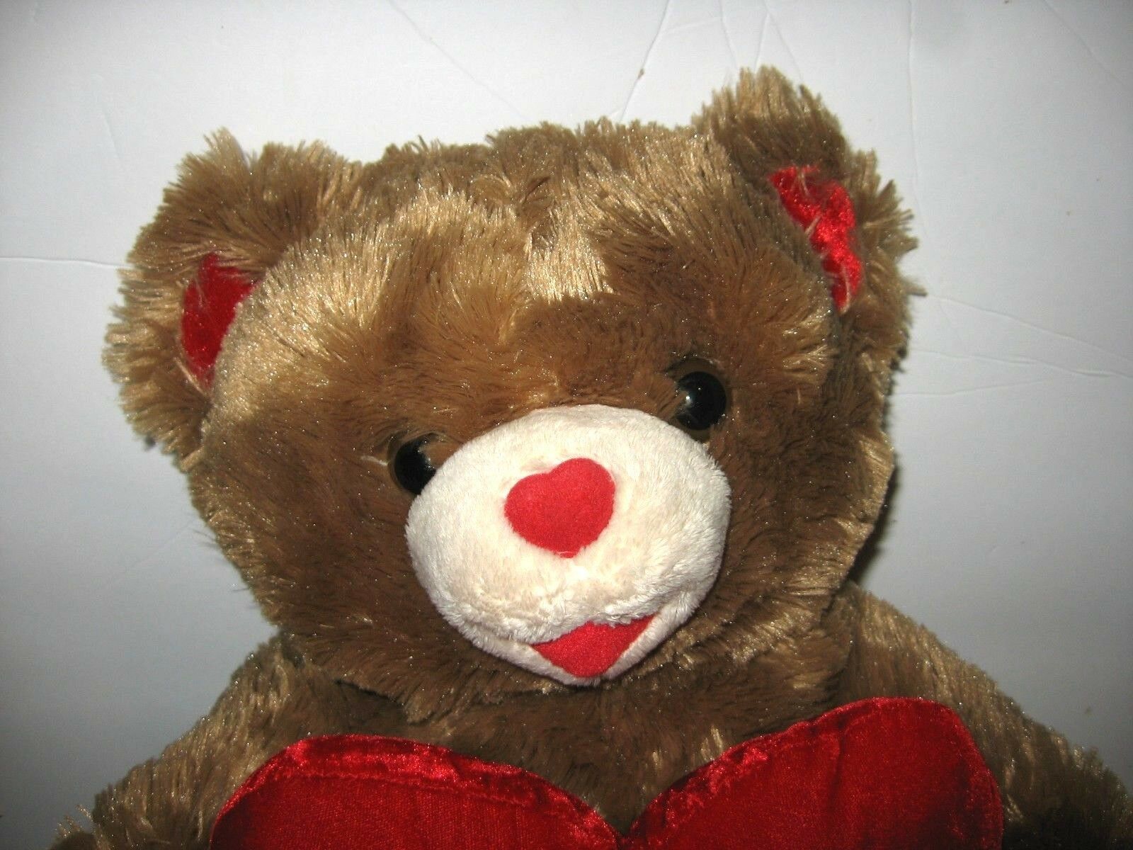 brown teddy bear with red heart