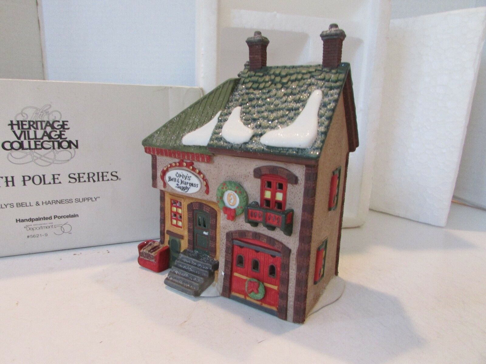 Department 56  North Pole Series "Orly's Bell&Harness Supply" #5621-9 in Box