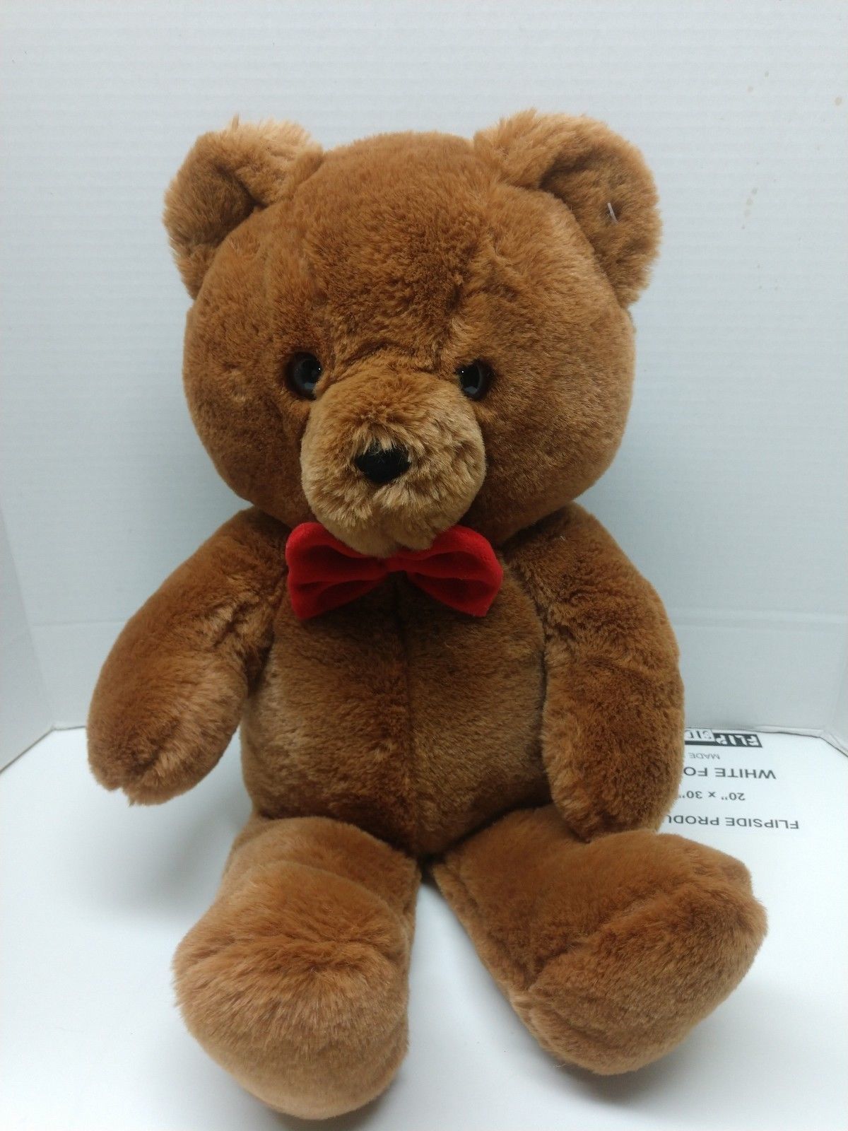 brown teddy bear with bow tie