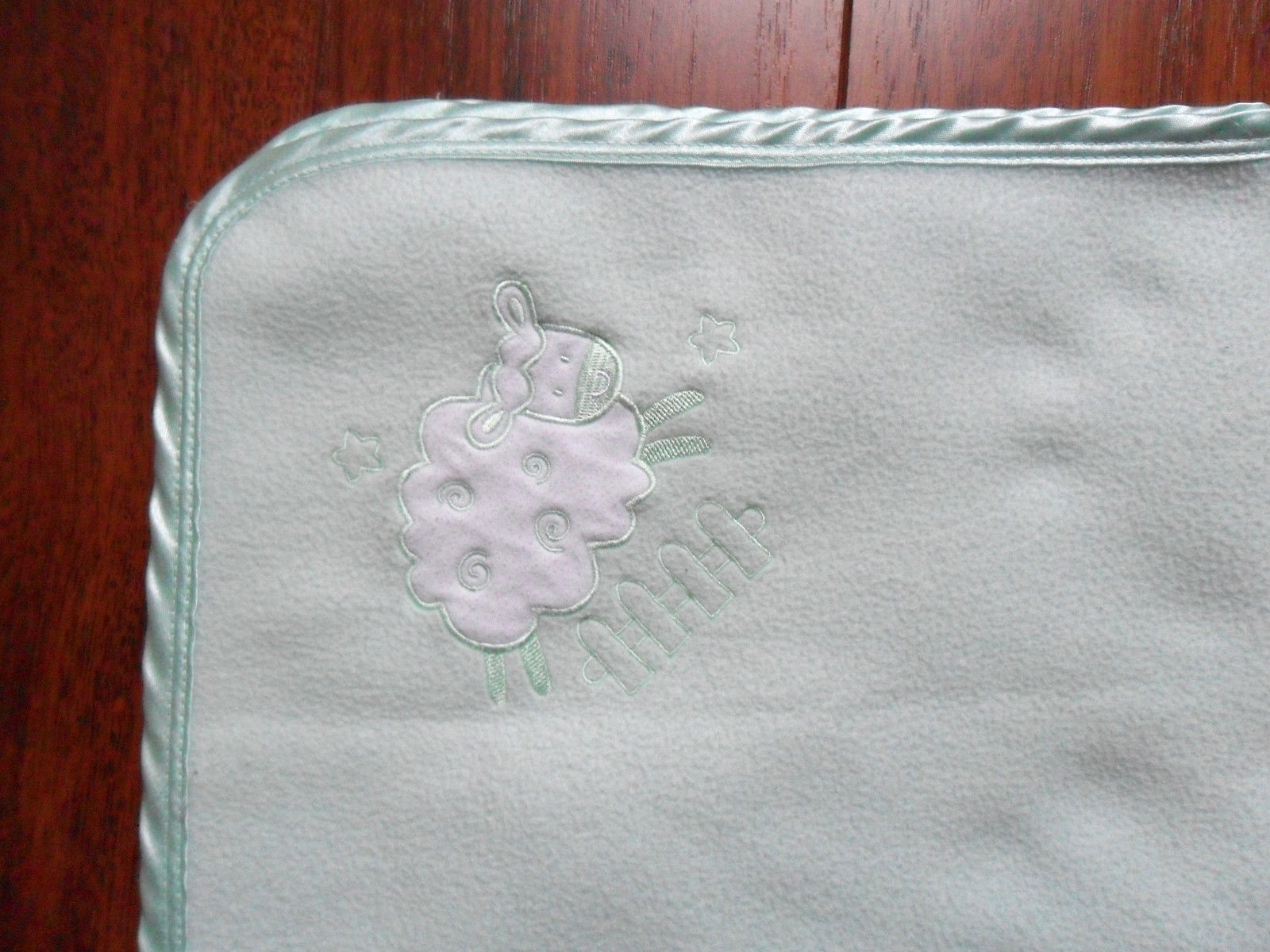 green baby blanket with satin trim