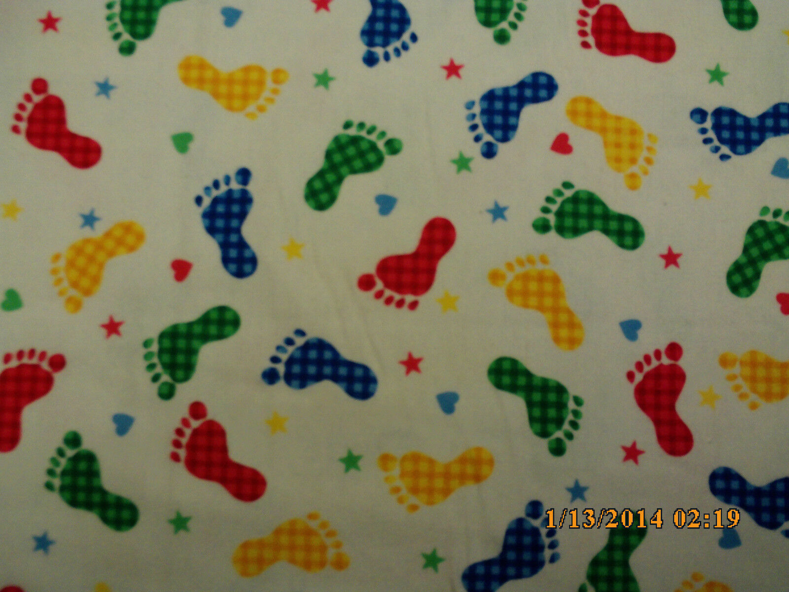 Primary image for White with Yellow, Green, Red, and Blue Baby Feet Flannel Fabric by the 1/2 Yard