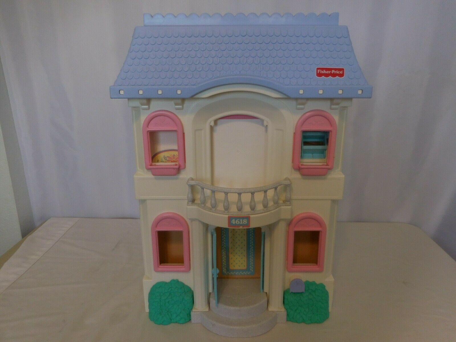 vintage fisher price dollhouse with blue roof