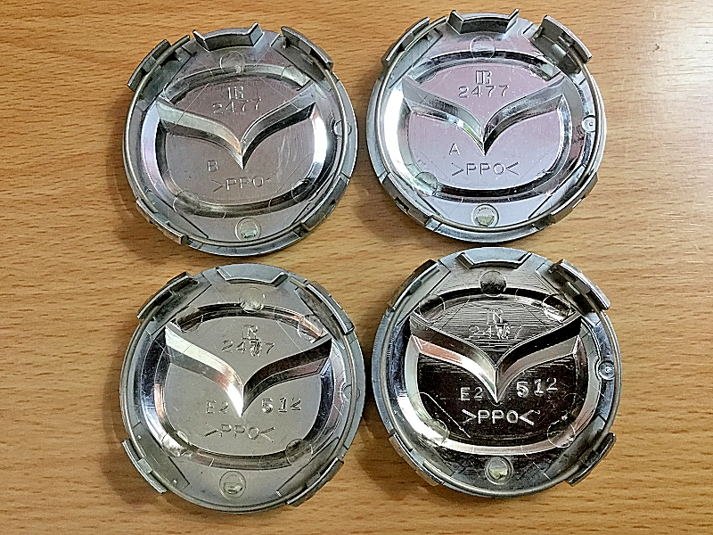 FOUR (4) USED MAZDA BLACK CAP, RAISED EMBLEM WHEEL CENTER HUBCAPS P/N