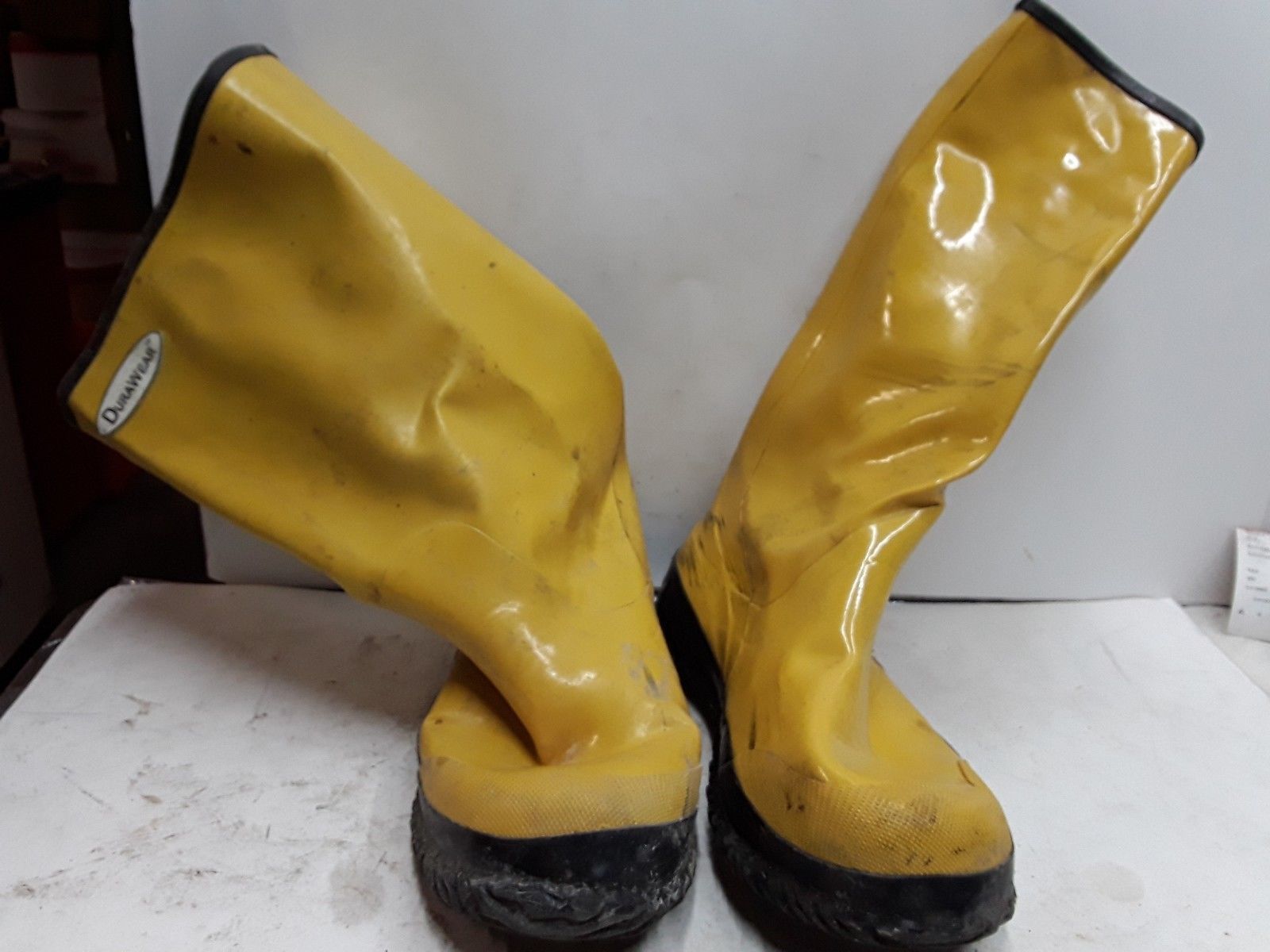 green rubber boots with yellow laces