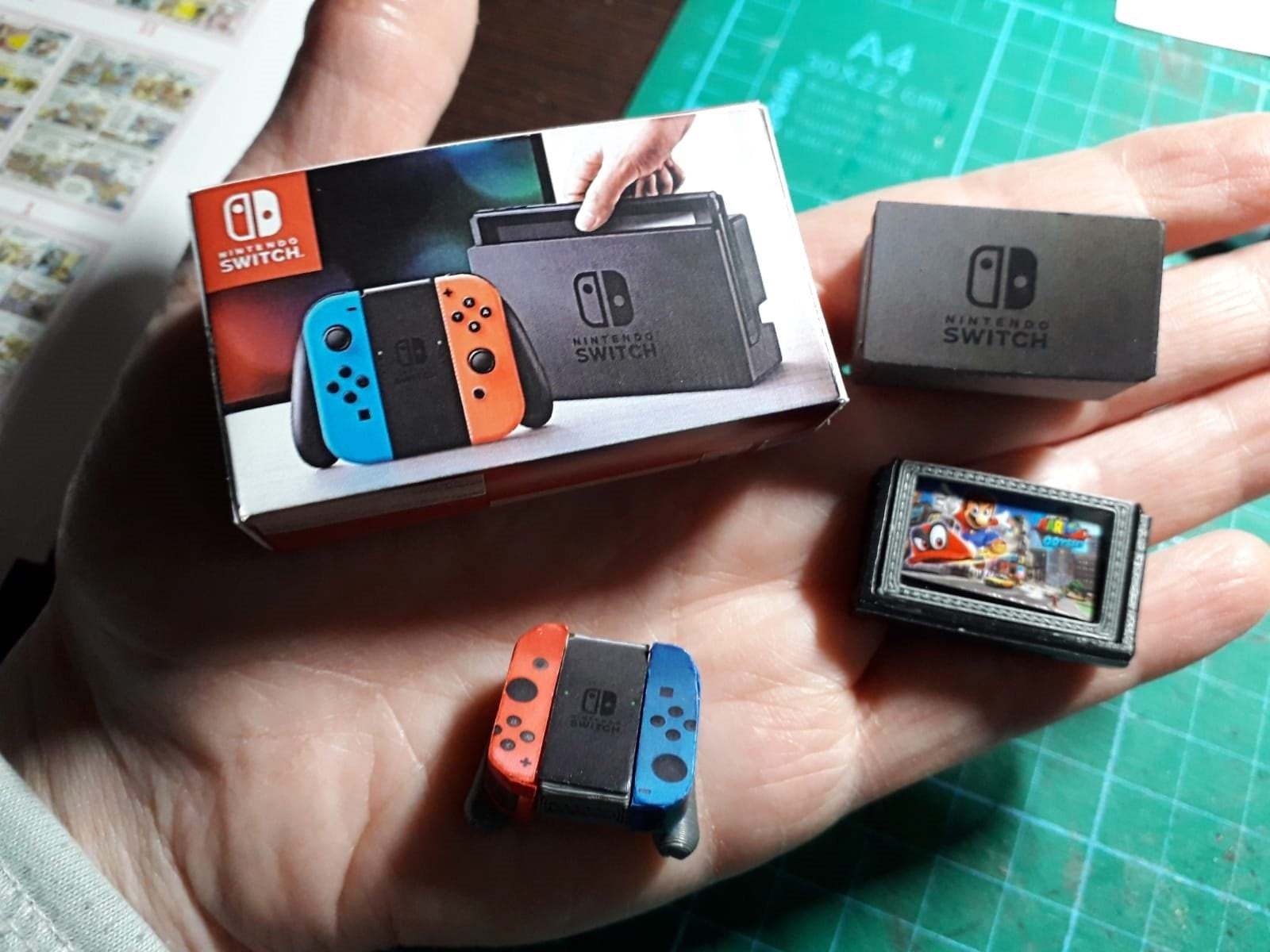 NINTENDO SWITCH. Miniature console with box and controllers. Merchandise