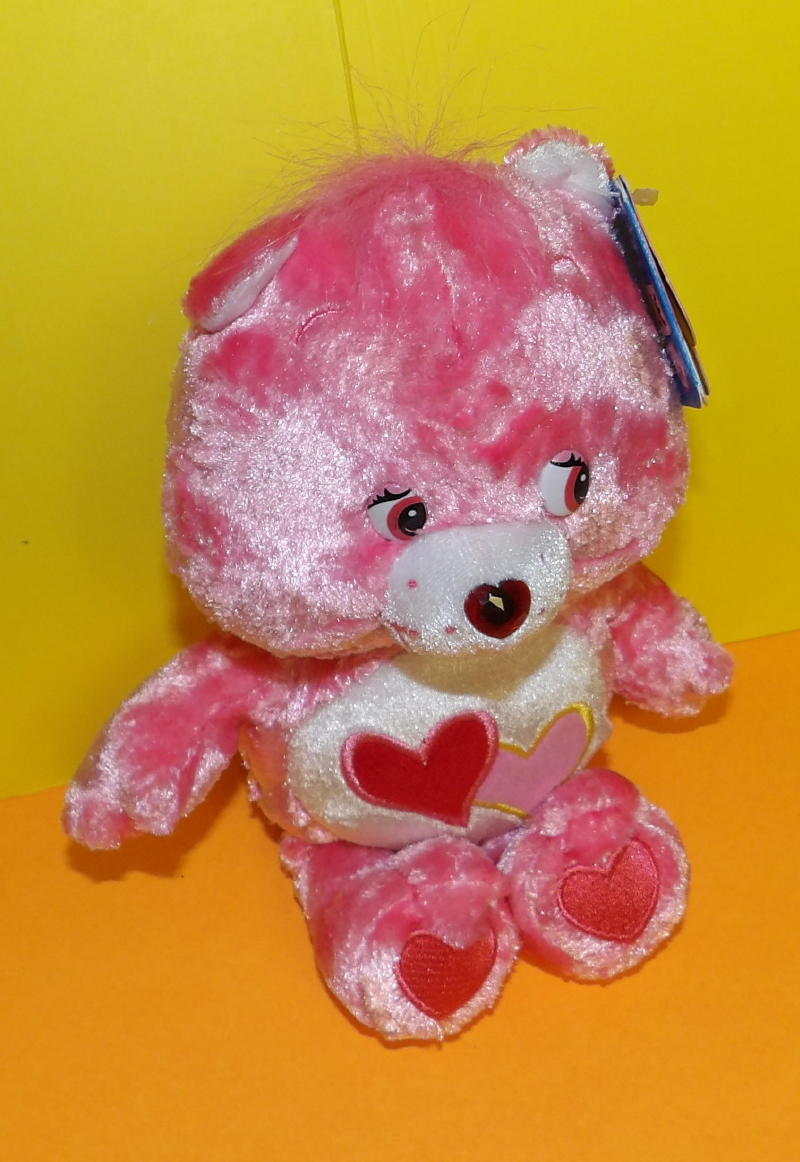 pink care bear with 2 hearts