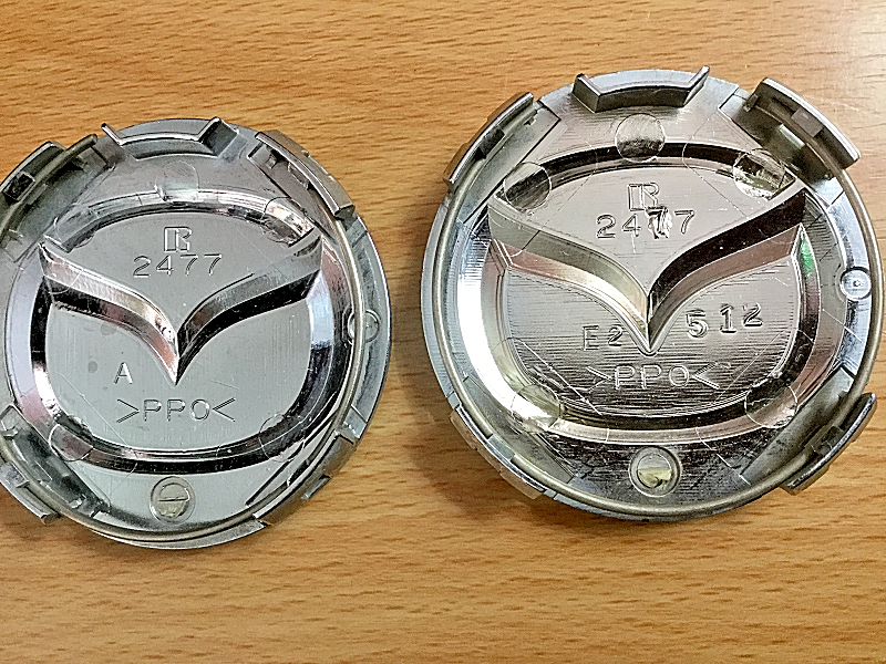 FOUR (4) USED MAZDA BLACK CAP, RAISED EMBLEM WHEEL CENTER HUBCAPS P/N