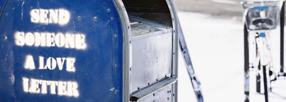 mailbox with the words Send Someone a Love Letter stenciled on the side