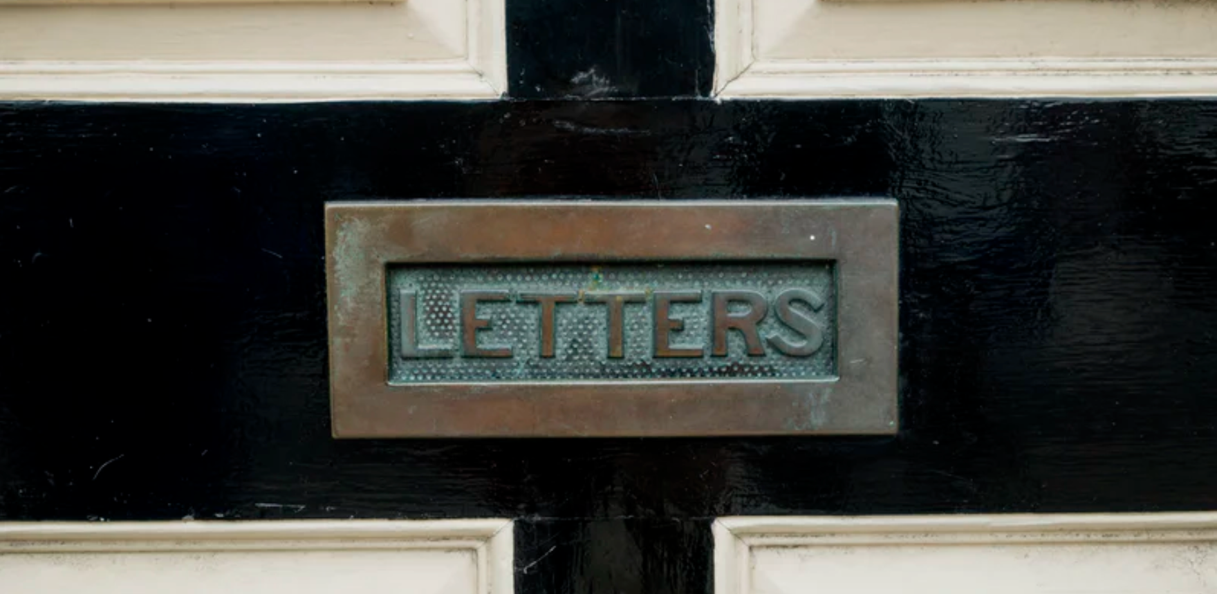 image of letter slot on black door