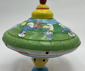 1982 Ohio Art Musical Smurf Spinning Tin Top Litho Metal Peyo, an item from the 'Smurfing Right Along' hand-picked list