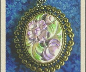 Hand-painted cameo pendant w soft muted purple flowers &amp; green leaves in bronze, an item from the 'Classic Cameos' hand-picked list